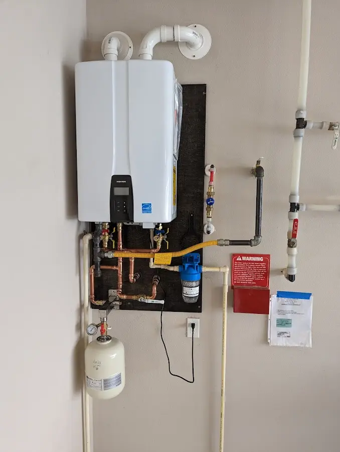 Professional plumber installing copper piping in a Bradley Beach home